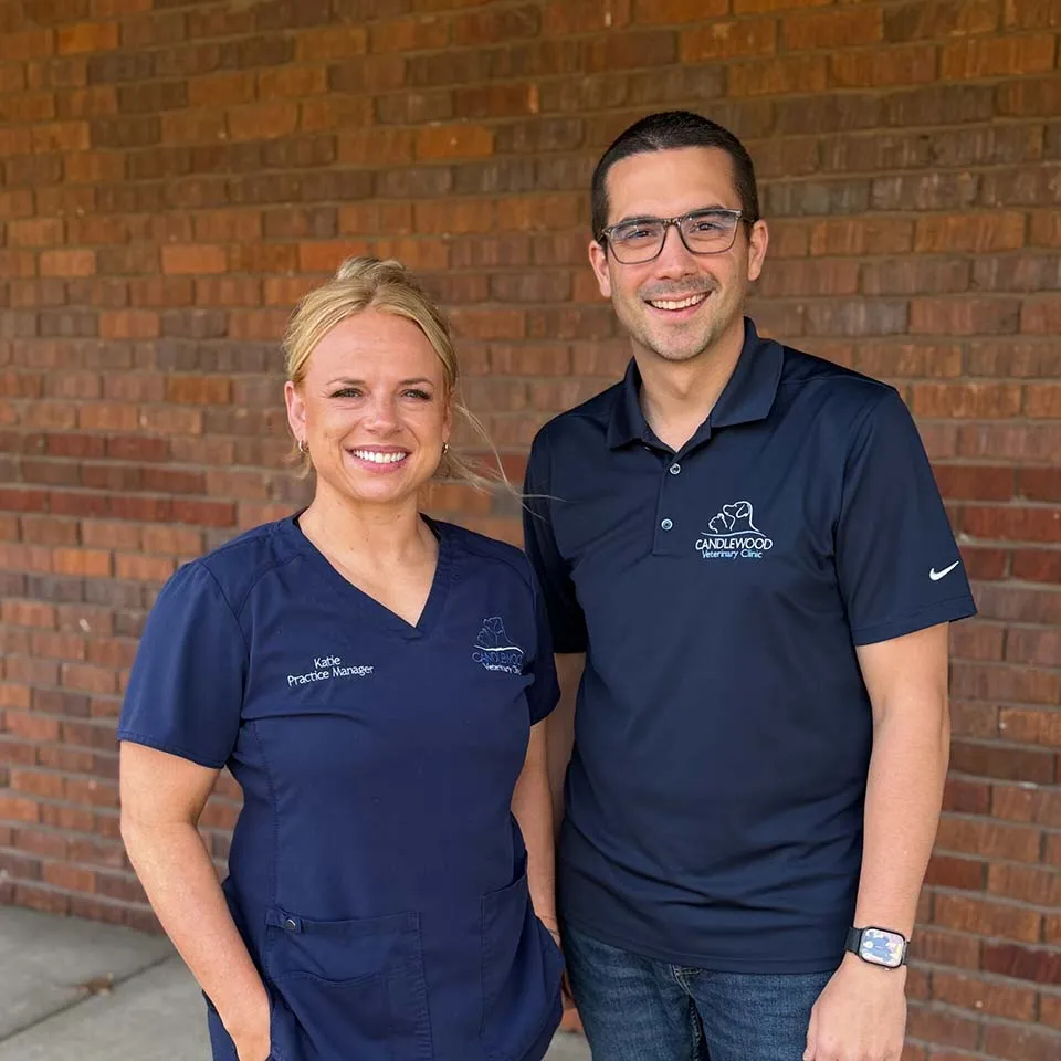 Katie and Cole in front of the clinic&rsquo;s brick wall