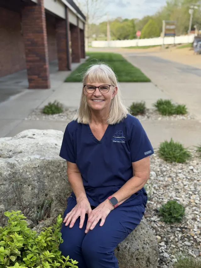Nancy, in navy Candlewood scrubs, outside the clinic